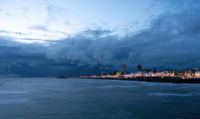 Brighton, England - September 12, 2019: Brighton Palace Pier and Seafront illuminated at night on the South Coast of England.