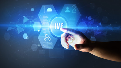 Fototapeta premium Hand touching IMF inscription, new technology concept