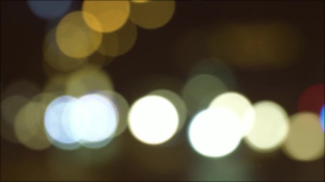 Defocused image of a night restaurant. Blurred lights with round bokeh as background.