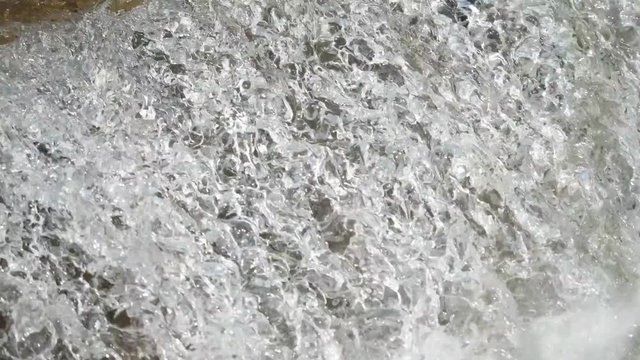 Detail pf waterfall, fast water flowing and splashing, the strong water energy