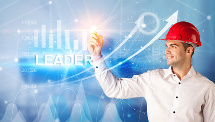 Young businessman with helmet drawing LEADER inscription, modern business technology concept