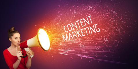 Young woman yelling to loudspeaker with CONTENT MARKETING inscription, social networking concept