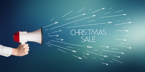 Young girl screaming to megaphone with CHRISTMAS SALE inscription, shopping concept