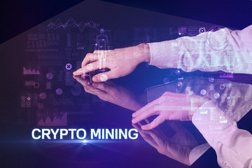 Businessman touching huge display with CRYPTO MINING inscription, modern technology concept