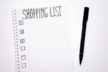 Shopping list. Squared notebook with black pen on a white background. Record ideas, notes, plans, tasks. The list includes bread, milk, bananas.  Copy Spase