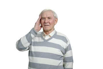 Old man feeling head pain. Upset grandfather with headache in white isolated background.