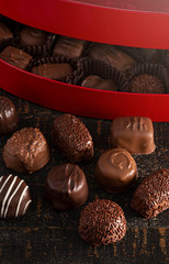 Red Heart Box of Chocolate Truffles on a Rustic Wooden Table