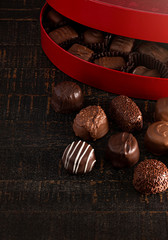 Red Heart Box of Chocolate Truffles on a Rustic Wooden Table