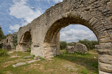 Fototapeta na wymiar The Historical Monument Aqueduct Romain de Barbegal. The Barbegal aqueduct and mills constitute a Roman complex of hydraulic milling located in Fontvieille, near the town of Arles, Provence, France