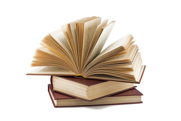 open book lies on other books isolated on white background