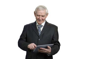 Senior in suit swiping tablet. Businessman working with tablet in white isolated background, cutout.