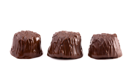 Three Dark Chocolate Truffles in a Row on a White Background