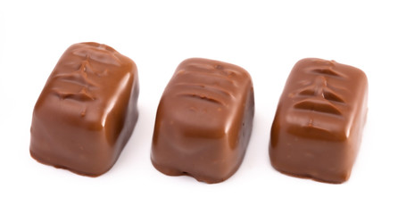 Three Milk Chocolate Truffles in a Row on a White Background