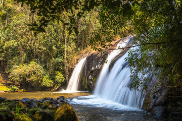 Waterfall in the middle of the Atlantic forest on a sunny day and very green.