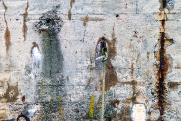 Rusty, old and weathered details on concrete harbour wall. Grunge, creative, texture, industrial and rustic look concept.