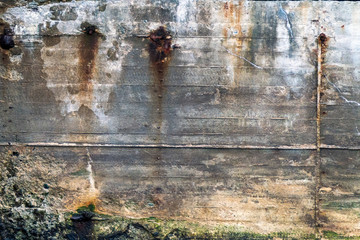 Rusty, old and weathered details on concrete harbour wall. Grunge, creative, texture, industrial and rustic look concept.
