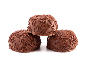 Three Milk Chocolate Truffles in a Row on a White Background
