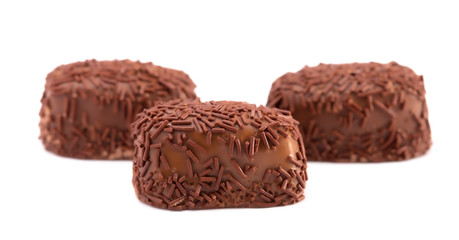 Three Milk Chocolate Truffles in a Row on a White Background