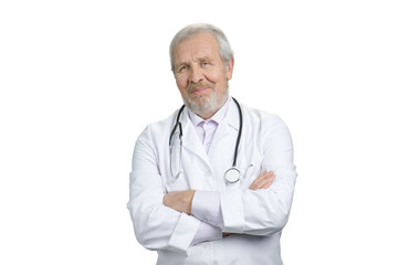 Senior doctor with arms crossed. White isolated background.