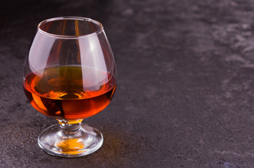 glass of cognac on a black background.Copy space	