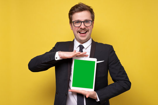 Successful Caucasian Young Business Man With Mustache Is Posing Showing Tablet Screen.