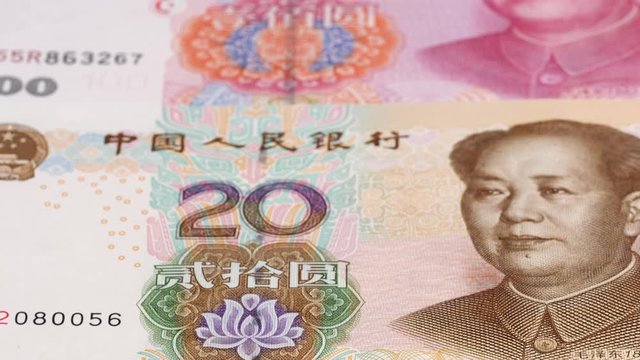 China yuan notes close up tracking. Yuan money background. Dolly shot, low angle. 4K, 422 10 bit