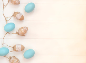 beautiful blue and beige easter eggs on wooden background