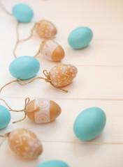 beautiful blue and beige easter eggs on wooden background