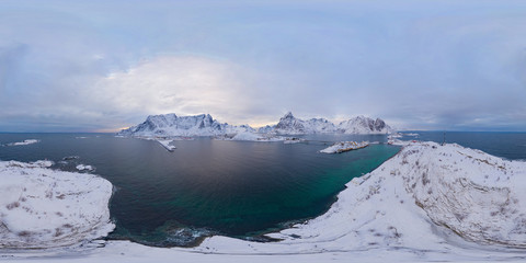 360 panorama by 180 degrees angle seamless panorama of aerial view of white snow mountain in Lofoten islands, Nordland county, Norway, Europe. Hills and trees, nature landscape in winter season.