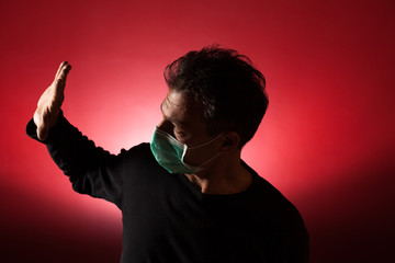 Portrait of  sick caucasian man with medical mask. Coronavirus Covid-19 concept. Red background 
