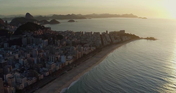 Aerial view of Ipanema and Copacabana Beach from helicopter. Sunrise light reflection on the ocean, Rio de Janeiro, Brazil. Light effect applied