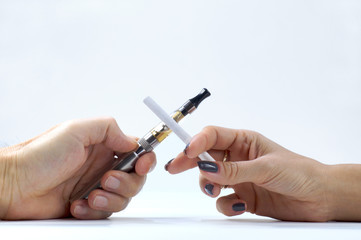 A man's hand with a cigarette and a woman's hand holding an e-cigarette. Addiction.