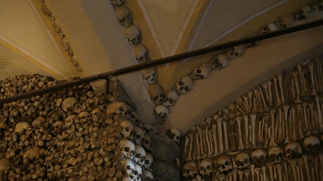 Chapel of Bones wall ceiling, skeletons, skulls, church, tilt down, Portugal