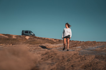 A woman walking on the beach.