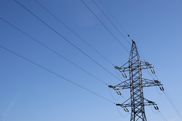 Power line against the blue sky. Electricity and sky. Power supply.