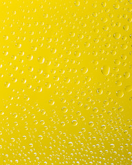 drops of water on a yellow glass