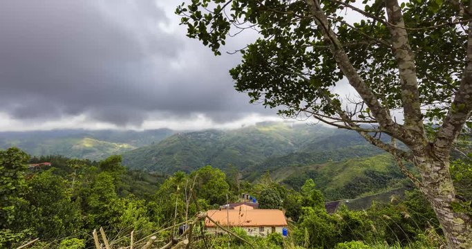 The beautiful landscape of the Borneo rainforest. On the way from Kota Kinabalu to Santakan, Sabah, East Malaysia. Passing by the Mount Kinabalu. A time lapse on the mountains with view in a valley