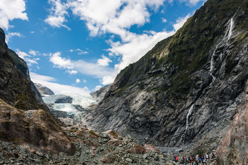 Fototapeta na wymiar tourists looking at franz josef glacier in new zealand