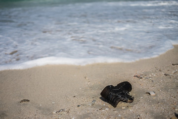 Garbage on the city beach. Pollution of the world's oceans with household waste, clothing and plastic. Territory of ecological disaster