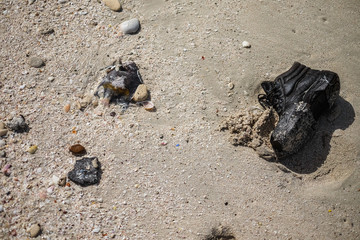 Garbage on the city beach. Pollution of the world's oceans with household waste, clothing and plastic. Territory of ecological disaster