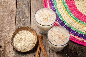 Mexican rice horchata with cinnamon on wooden background