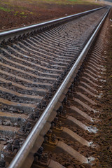 railway line. rails and concrete sleepers extending into the distance. travel by train.