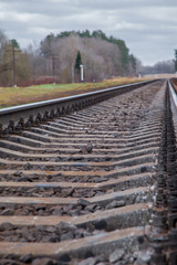 railway line. rails and concrete sleepers extending into the distance. travel by train.
