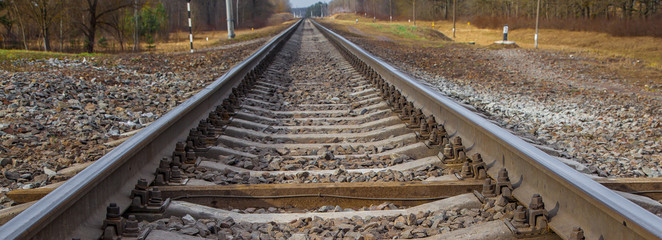railway line. rails and concrete sleepers extending into the distance. travel by train.