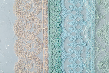 A variety of lace on a shabby background, a textile product with an ornamental design, openwork pattern formed by interweaving
