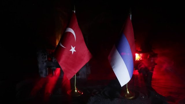 Closeup, flags on dark background. Concept of crisis of war and political conflicts between nations. Selective focus