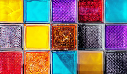 Colored glass blocks with embossed patterns. Multi-colored glass squares.