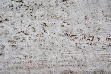 close-up of damaged stone structure textured with holes