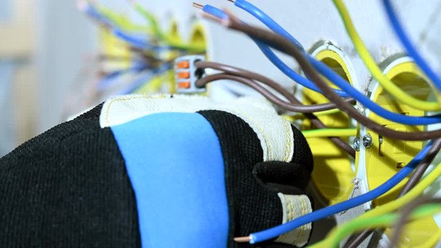 Contractor Ties Alike Wires Together To Connect Them With Lever Nut Connector. 
