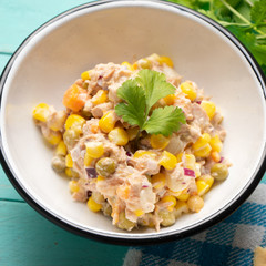 Tuna salad with mayonnaise on turquoise background